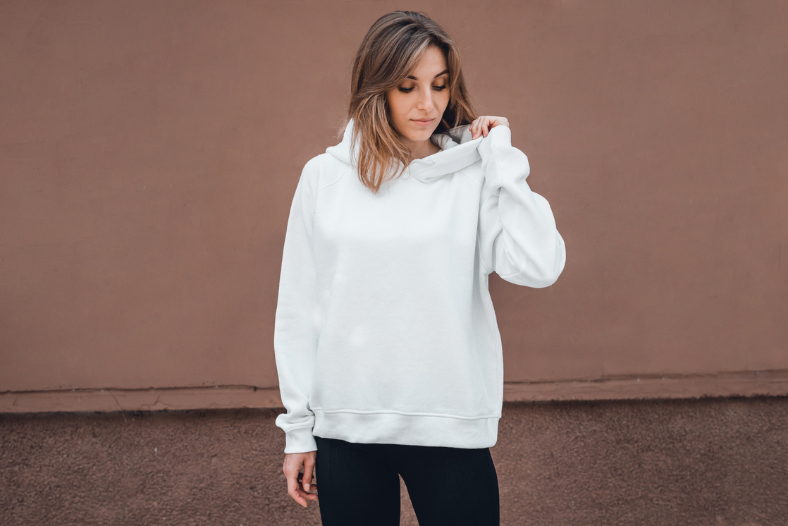 White hoodie on a young woman, mockup.